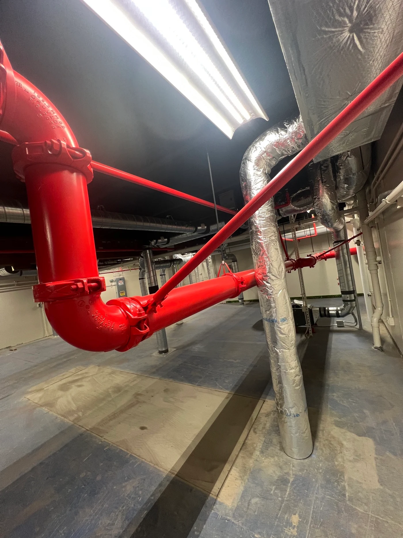 Industrial red fire suppression piping coating at USCG Kodiak Building N1
