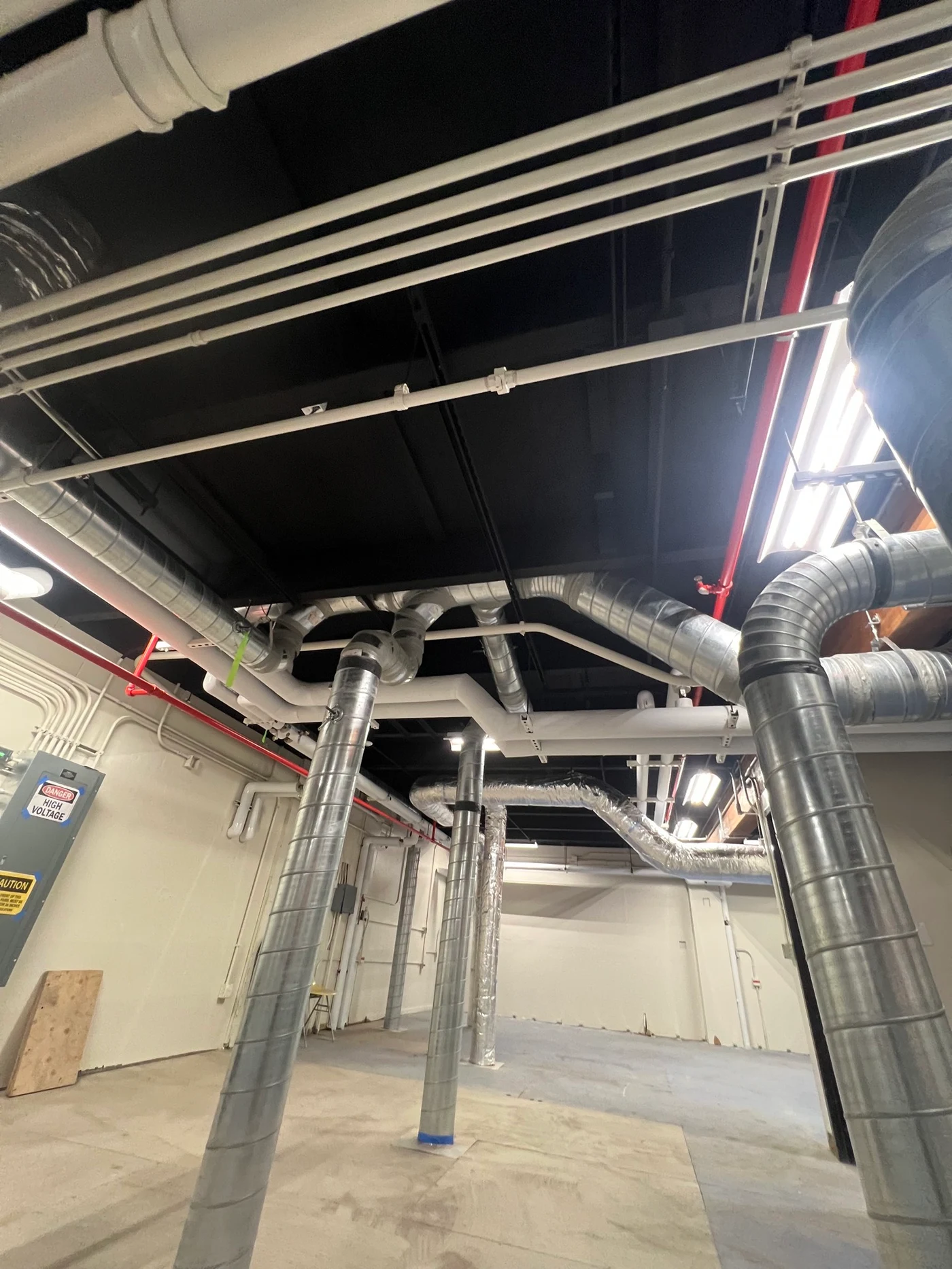 High bay ceiling blackout coatings and utility lines at USCG Kodiak Building N1